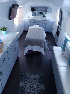 an airplane bedroom with a bed in the middle and a sink on the other side