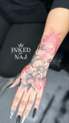 a woman's hand with flowers on it