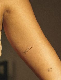 a woman's arm with the word love written in small letters on her left arm