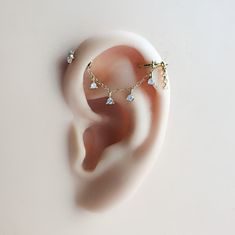 a pair of ear piercings sitting on top of a white surface