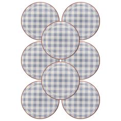 four blue and white checkered plates sitting on top of each other in the shape of circles