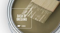 a paint can with a brush in it that says dash of oregano