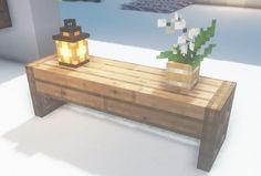 a wooden table with a potted plant on it and a lit candle sitting on top