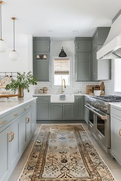 a kitchen with gray cabinets and an area rug