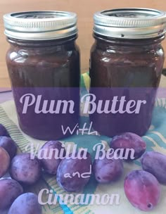 plum butter with vanilla bean and cinnamon in two mason jars on a table next to grapes