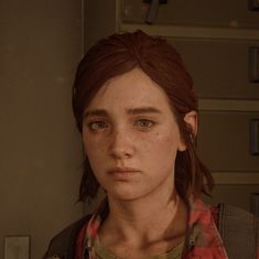 a woman with freckled hair standing in front of a locker