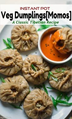 some dumplings on a plate with dipping sauce