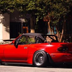 a red sports car parked in front of a building