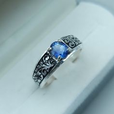 a ring with a blue stone in it