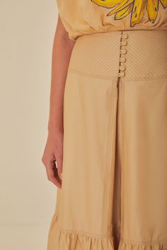 Step into the warmth of the season with the Khaki Topstitching Yoke Organic Cotton Maxi Skirt. This earth-toned piece is thoughtfully crafted from organic cotton, featuring topstitched yoke detailing that adds an artisanal touch to the simple elegance of the skirt. The gentle flare and ruffled hem create a breezy silhouette, making it a perfect match for sunkissed days. Embrace the effortless charm of this skirt, a testament to the conscious fashion choices of the modern woman. 100% Certified Or Yoke Skirt, Cotton Maxi Skirt, Cotton Maxi Skirts, Water Usage, Conscious Fashion, Cotton Maxi, Farm Rio, Simple Elegance, Environmental Impact