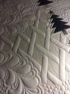 a close up view of a quilt with stars on it