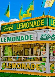 a lemonade stand with flags flying in the background