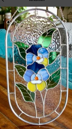 a close up of a stained glass window on a wooden table with text overlay