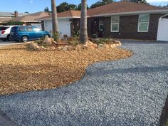 a gravel driveway in front of a house