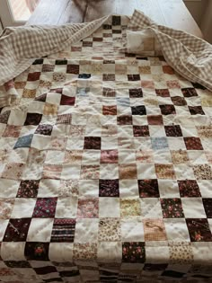 a bed with a checkered blanket on top of it