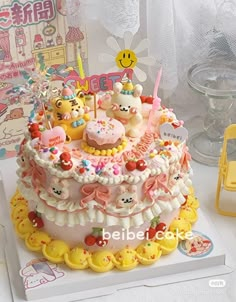 there is a large cake with many different decorations on the top and bottom tiers