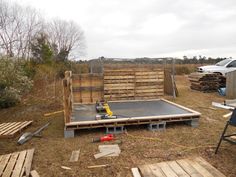 a wooden pallet is being built in the yard