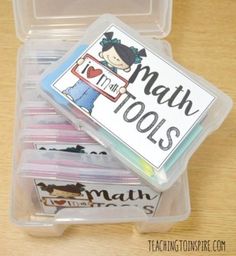 a plastic container filled with lots of pencils and writing paper on top of a wooden table