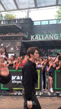 two people walking in front of a crowd