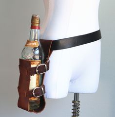 Everyone wishes they could carry their bottle full of choice delicious drink, be it alcoholic or not, but often don't want the arduous task of carrying it in their hands. You need not have this worry anymore! Holster your tasty beverage at your side and be ready for a quick draw quaffing at anytime. This cowhide leather holster is adjustable and will fit many different sizes of bottles and comes in a few color choices. Adjusts with two buckles Simply slides onto a belt Book Holster, Knife Holster, Front Pocket Wallet, Quick Draw, Pocket Wallet, Ex Machina, Fantasy Clothing, Character Outfits, Larp