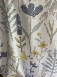 a close up view of a curtain with flowers on the outside and yellow leaves on the inside