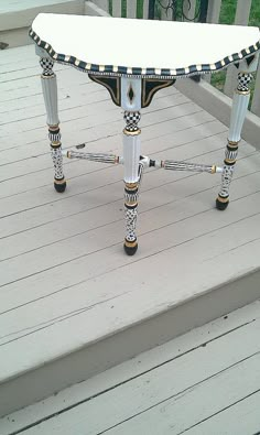 an ornately decorated bench on a deck