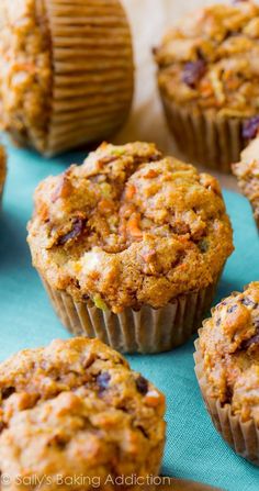 several muffins sitting on top of a blue surface