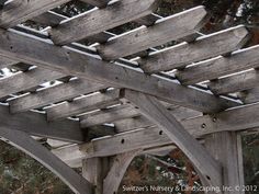 a wooden structure with snow on the ground