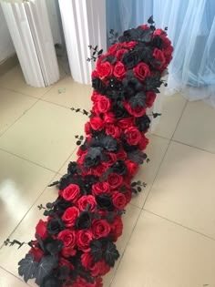 a bunch of red and black flowers on the floor