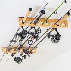 several fishing rods and reels are hanging from the ceiling