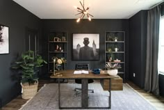 an office with black walls and wooden desk