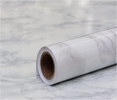 a roll of white paper sitting on top of a marble counter