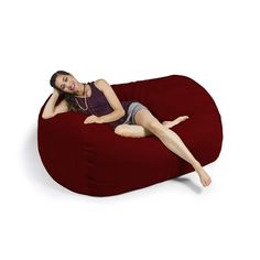 a woman is laying on a bean bag chair