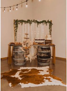 a table with two wine barrels on top of it and a cowhide rug in front of it