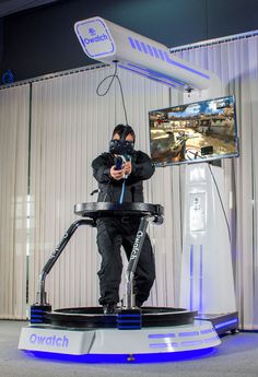 a man standing on top of a machine while holding a cell phone