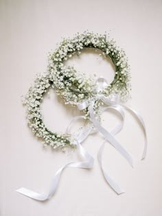 two wreaths with white flowers tied together