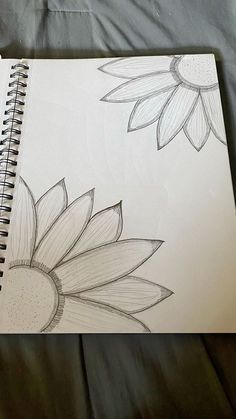 a drawing of two sunflowers on a sheet of paper next to each other