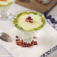 two desserts are sitting on a table with spoons