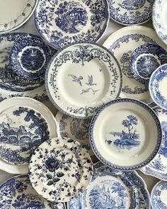 many blue and white plates stacked on top of each other