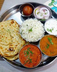 a metal plate topped with different types of food