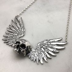 "You'll never be the same after you buy this winged skull pendant. A great piece of jewelry to add to your collection or gift for a loved one. Solid oxidised heavy 925 sterling silver winged skull pendant on an adjustable 925 silver chain. Pendant measures 9.5cm in width. Picture shows 25\" chain. 925 Sterling Silver. Each piece is handmade to order in the Jewel Thief Brighton atelier." Gothic Winged Jewelry Gift, Gothic Winged Jewelry For Gifts, Collectible Silver Skull Necklace, Skull With Wings, Winged Skull, Silver Chain Pendant, Necklace Gothic, Diamond Eyes, Silver Wings