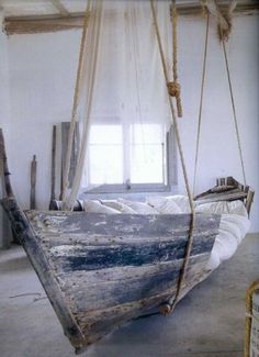 an old boat is hanging from a rope