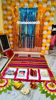 a table topped with lots of food and balloons