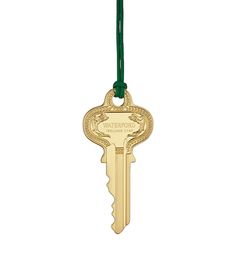 a gold key hanging from a green cord