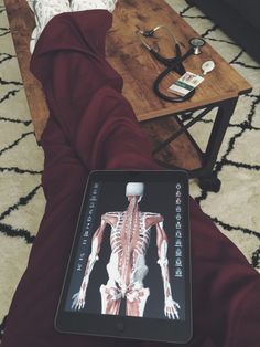 a person sitting on the floor with their feet propped up in front of an ipad