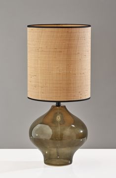 a lamp that is on top of a table with a light shade over the base