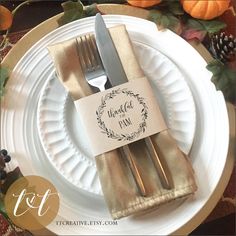 a white plate topped with a fork and knife next to a napkin on top of it