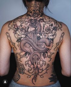 the back of a woman's body with tattoos on her upper and lower half