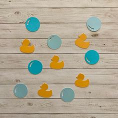 several rubber ducks and blue circles on a wooden surface