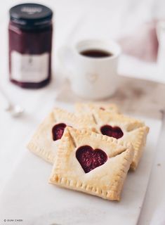 two heart shaped pastries sitting on top of a white plate